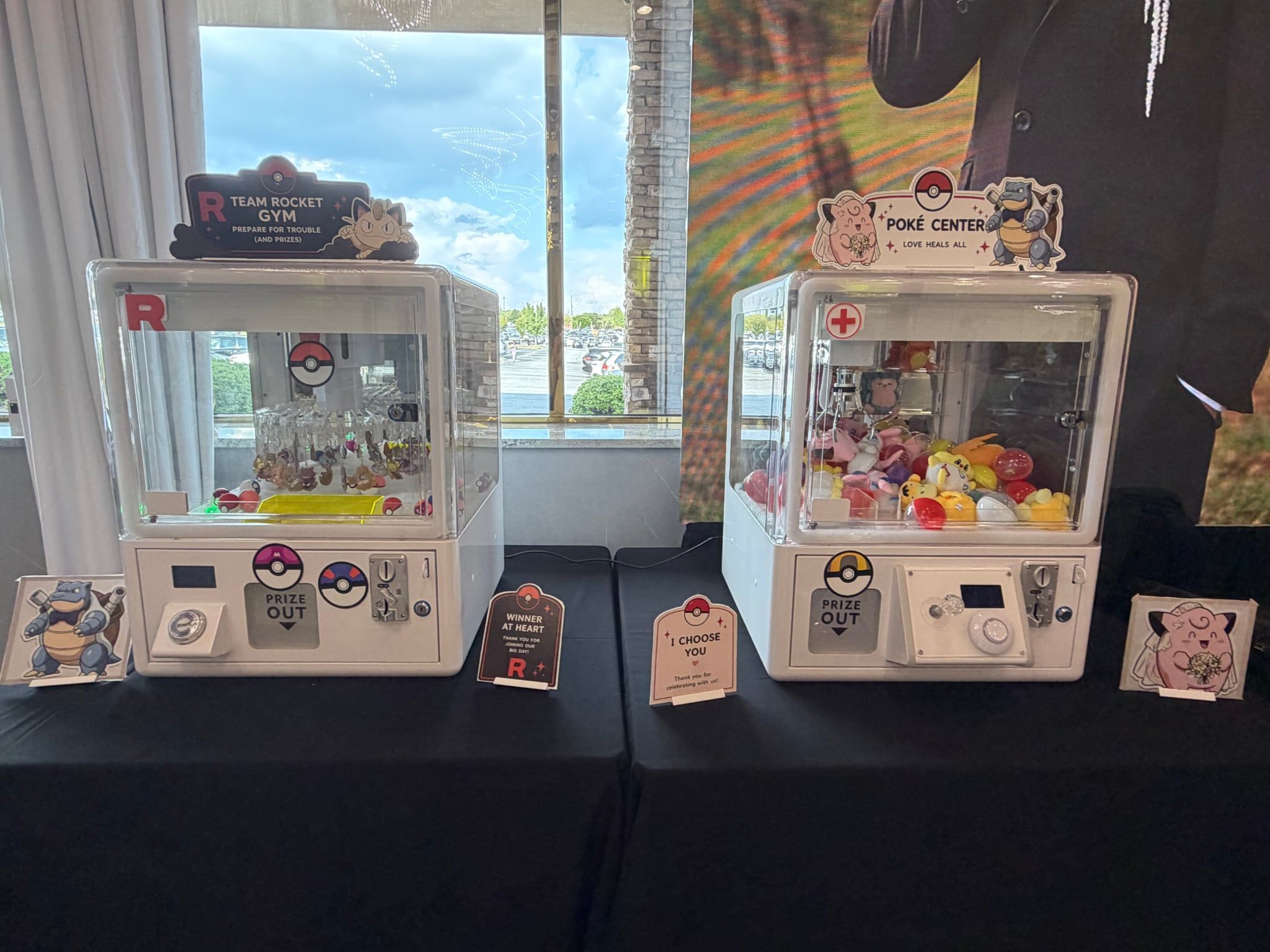 Two custom-themed claw machines side by side at a wedding reception